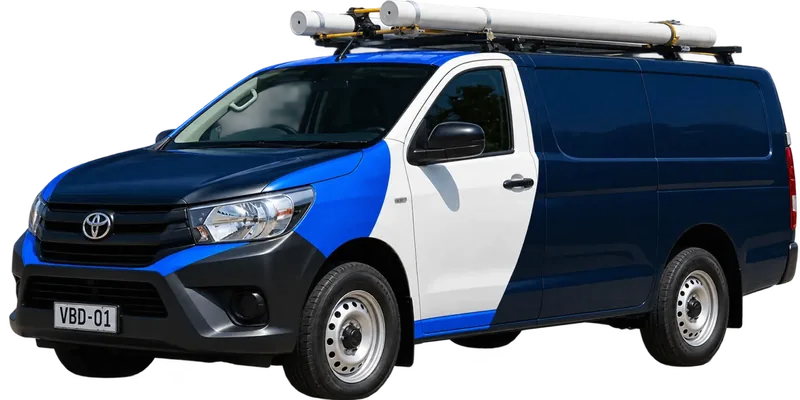 A licensed Eastwood plumbing van loaded with pipe on the roof rack